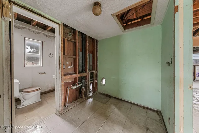 a spacious bathroom with a toilet a sink and mirror