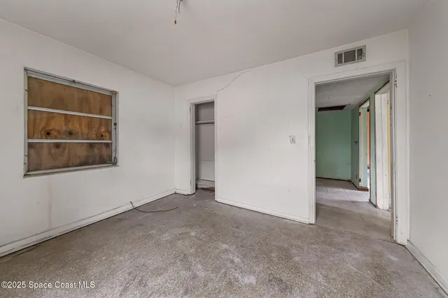 a view of an empty room with a window