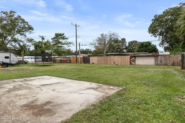 a front view of house with yard and trees