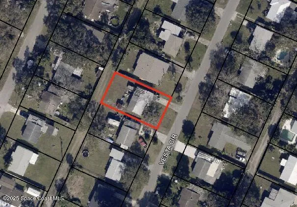 an aerial view of a building with parking area