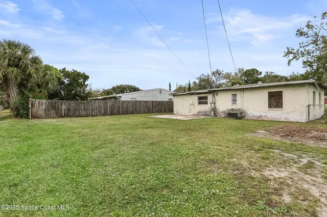 a front view of house with yard and trees