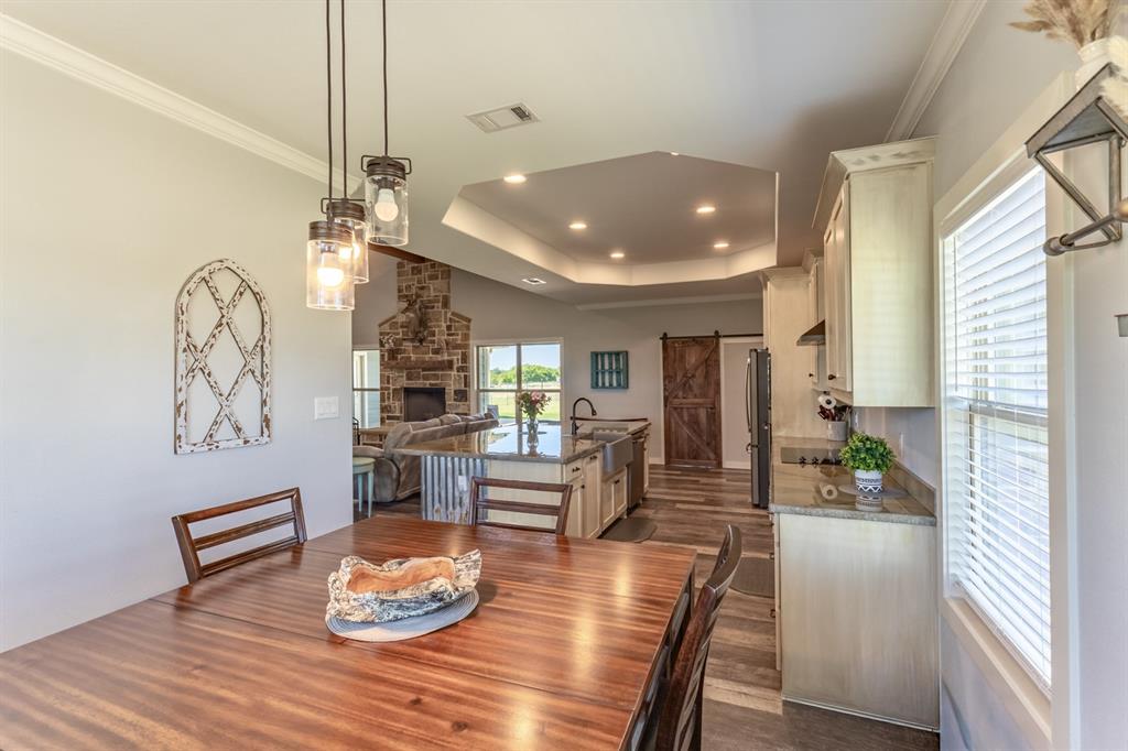 14910 Old Stoney Road Ponder, TX 76259 - Photo 11 of 36 a living room with dining table and wooden floor