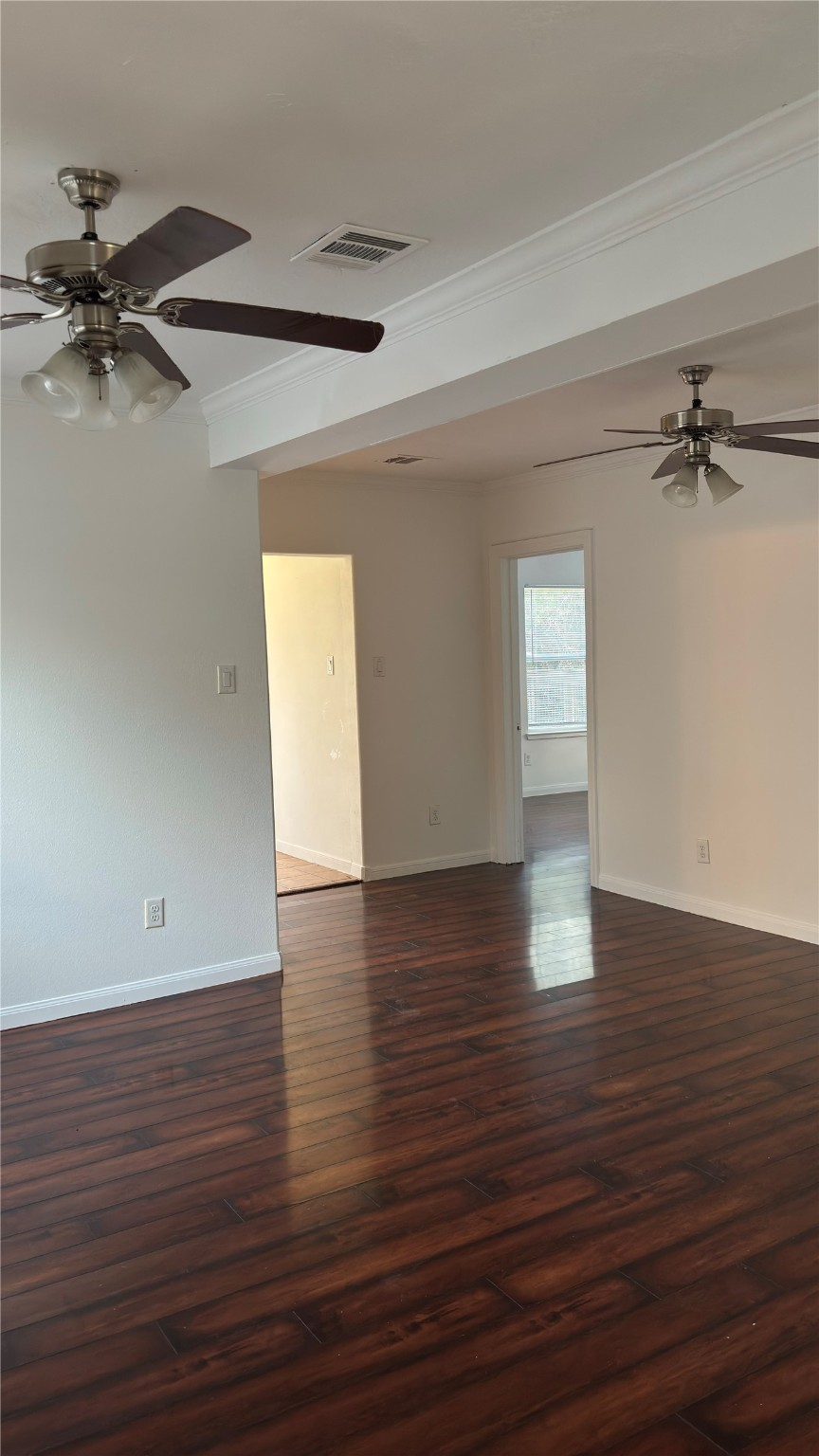 4911 Oleander Street, Unit B Pasadena, TX 77586 - Photo 11 of 34 a view of a room with wooden floor and a ceiling fan