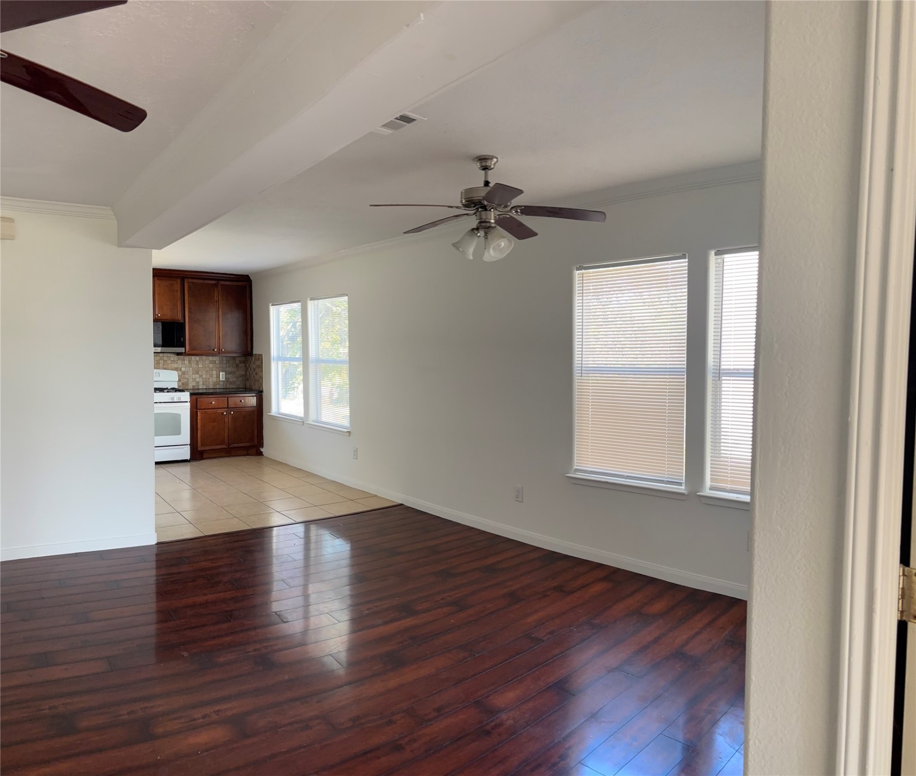 4911 Oleander Street, Unit B Pasadena, TX 77586 - Photo 12 of 34 a view of empty room with wooden floor and fan