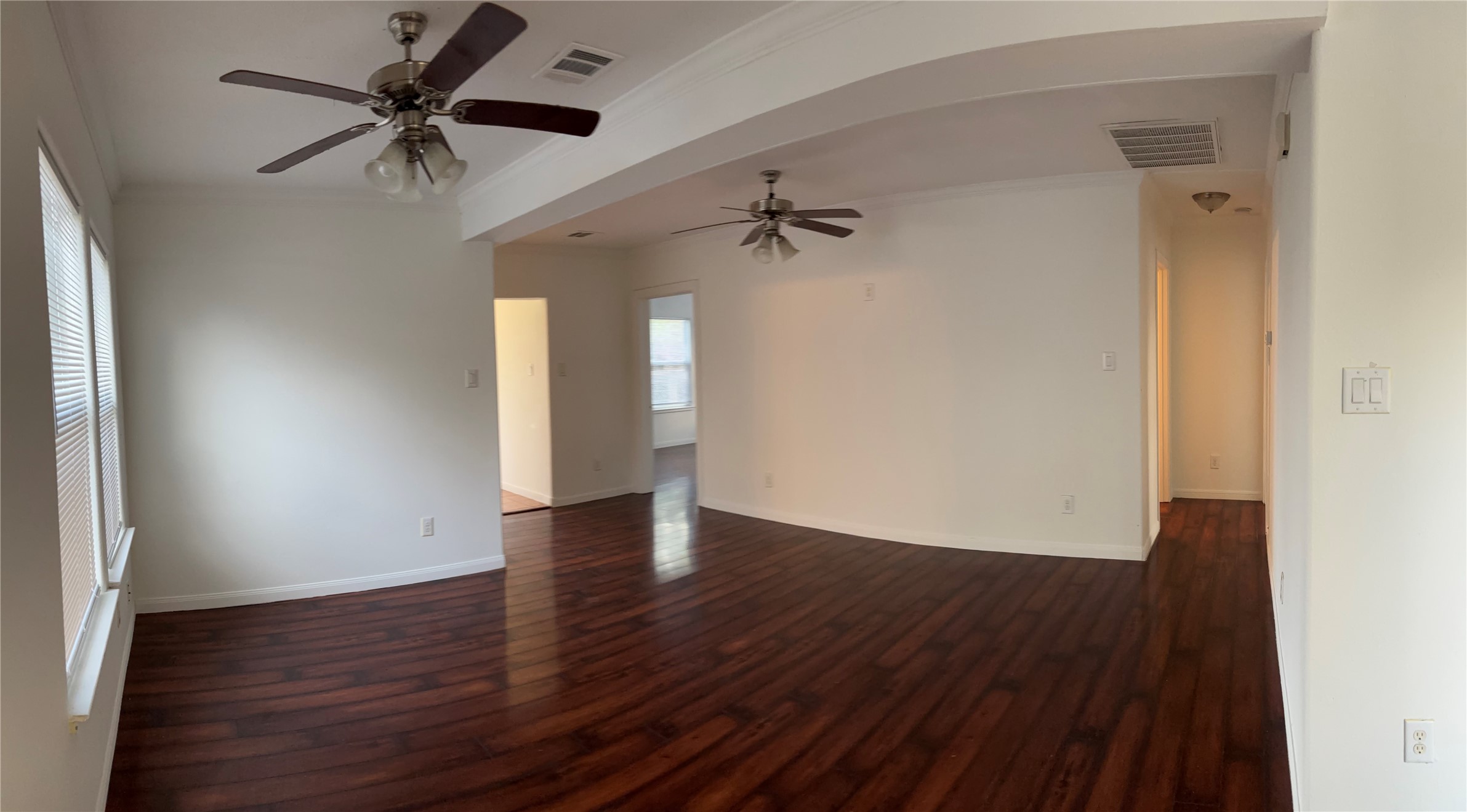 4911 Oleander Street, Unit B Pasadena, TX 77586 - Photo 7 of 34 a view of an empty room with a window and wooden floor