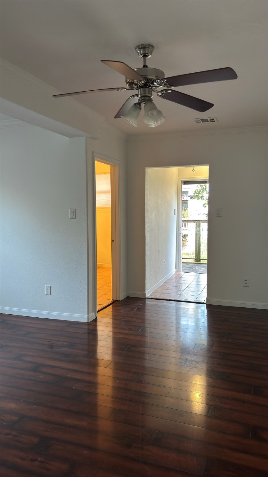 4911 Oleander Street, Unit B Pasadena, TX 77586 - Photo 9 of 34 an empty room with wooden floor and windows