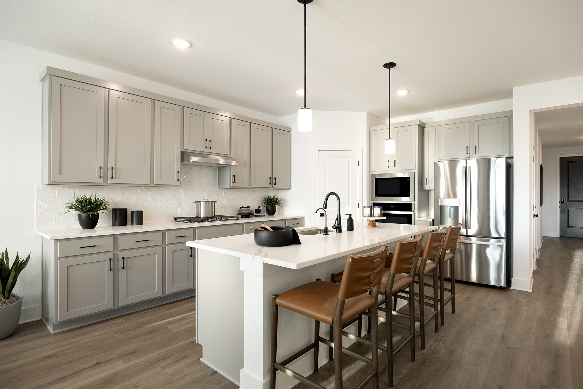 270 Romans Road Kyle, TX 78640 - Photo 2 of 23 a kitchen with stainless steel appliances kitchen island granite countertop a table chairs sink and cabinets
