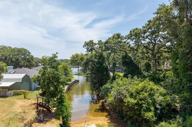 a view of a lake in middle of forest
