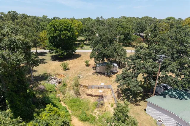 a view of a lake with large trees