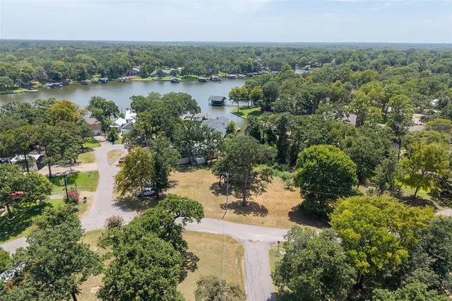 an aerial view of a house with a lake view