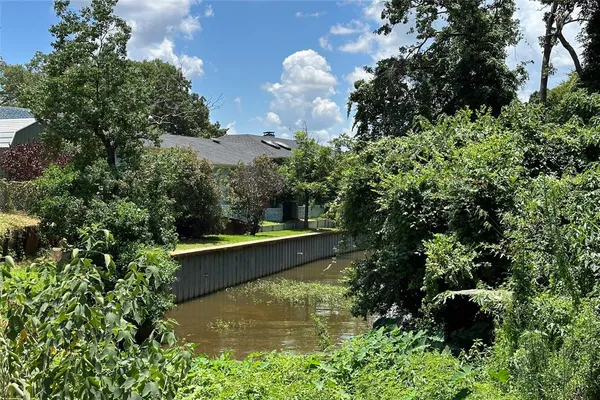 an aerial view of a house with a yard and swimming pool