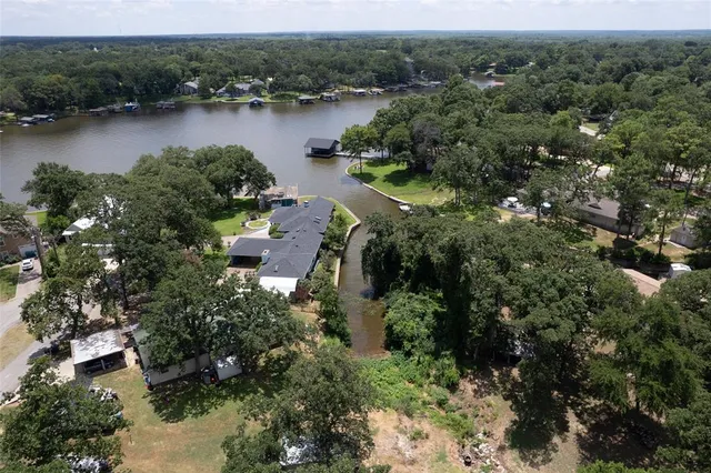 an aerial view of residential house with outdoor space and lake view