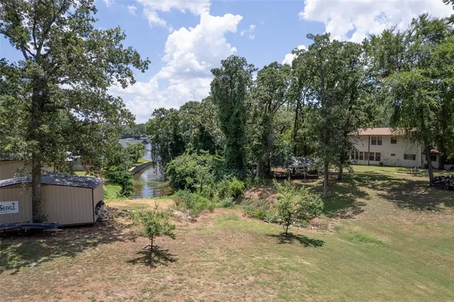 a view of backyard with a table and chair and barbeque oven