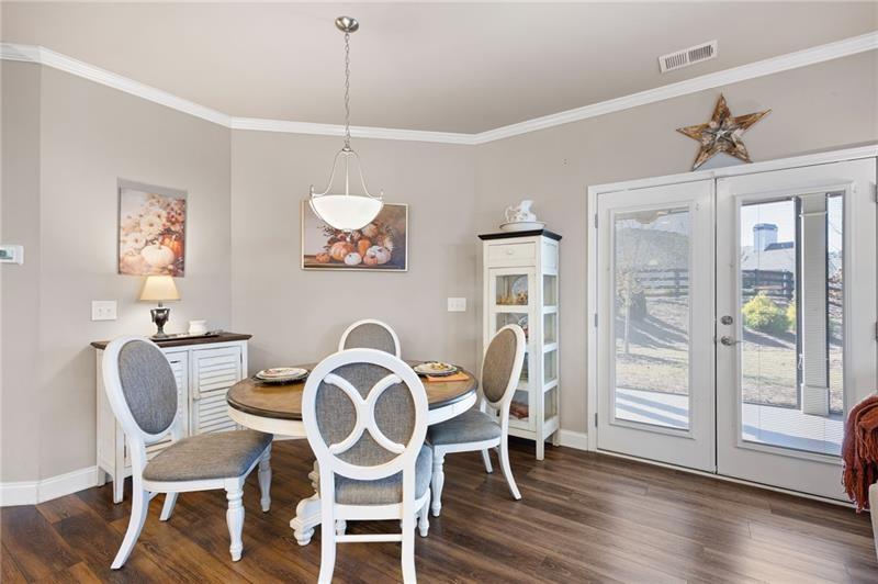 80 Azalea Crossing Dallas, GA 30132 - Photo 18 of 38 a dining room with furniture a chandelier and wooden floor