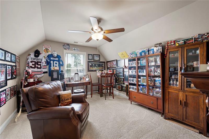 80 Azalea Crossing Dallas, GA 30132 - Photo 26 of 38 a living room with furniture a ceiling fan and a book shelf