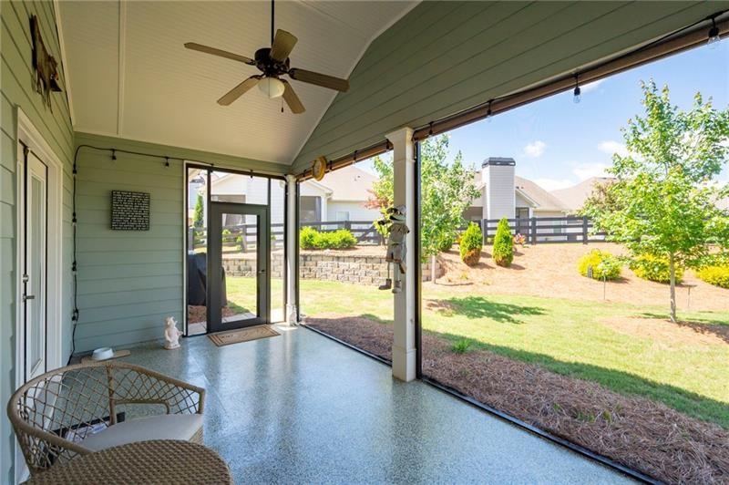 80 Azalea Crossing Dallas, GA 30132 - Photo 31 of 38 a living room with hardwood floor and a large window with garden view