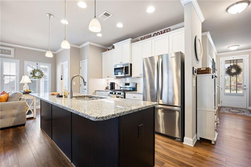80 Azalea Crossing Dallas, GA 30132 - Photo 9 of 38 a kitchen with stainless steel appliances granite countertop a sink refrigerator and cabinets