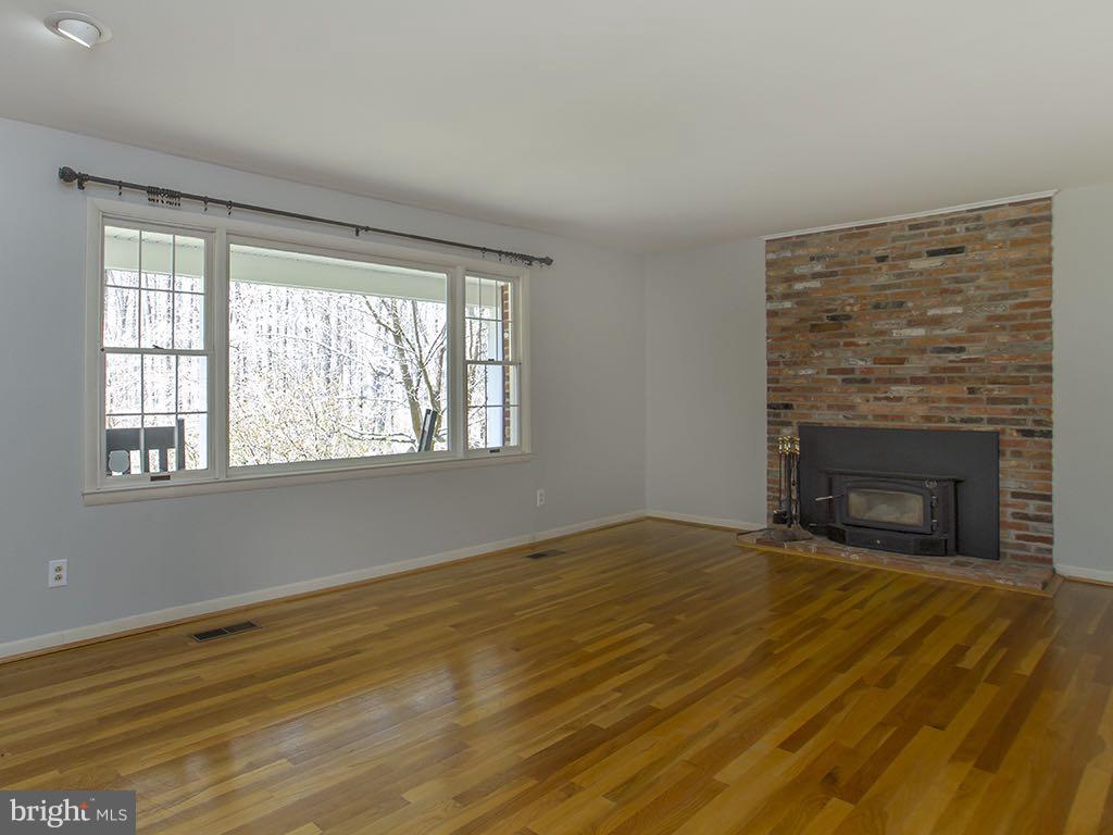 17207 Wesley Chapel Road Monkton, MD 21111 - Photo 2 of 30 Main lvl living rm with wood stove