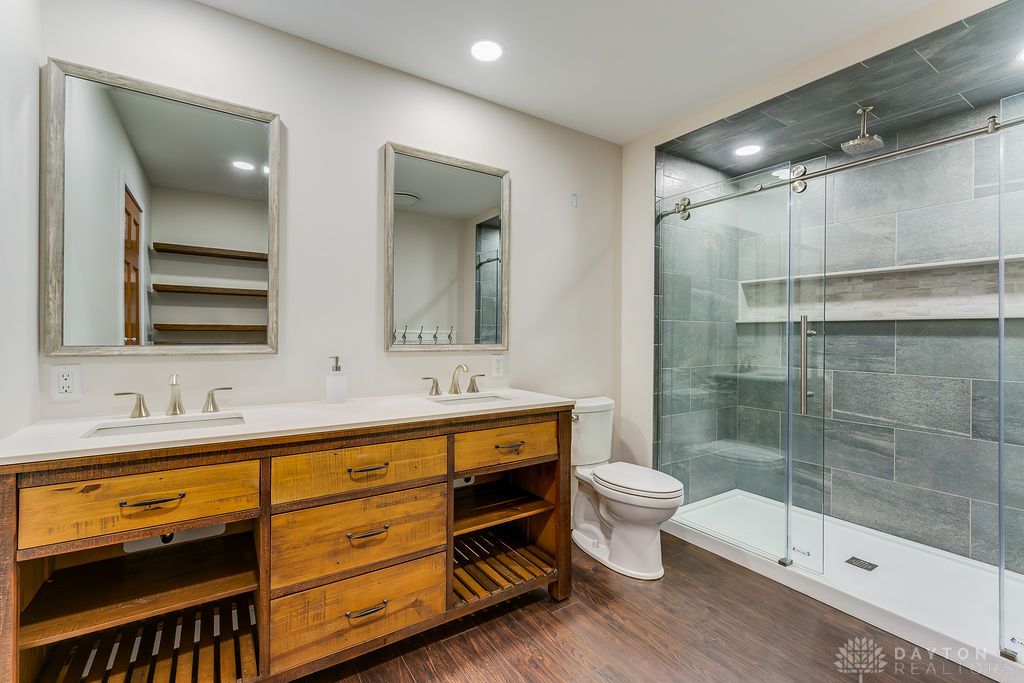 7400 Cook-Jones Road Waynesville, OH 45068 - Photo 30 of 72 This bathroom features a double vanity and a glass-enclosed shower, offering comfort and convenience.