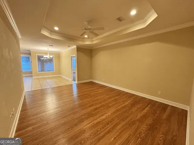 a view of a room with wooden floor