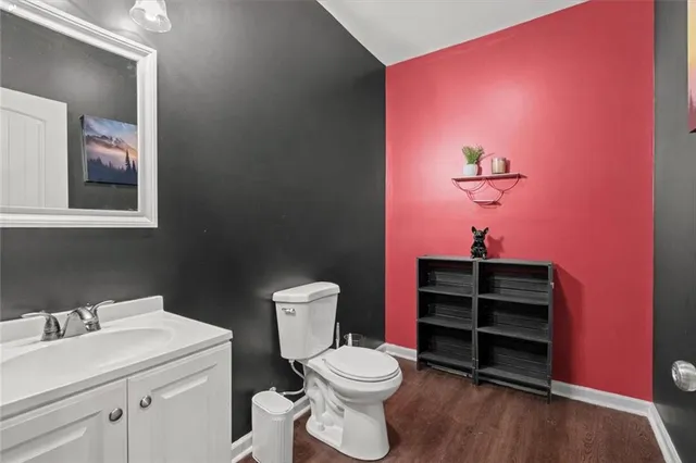 a bathroom with a toilet sink and vanity