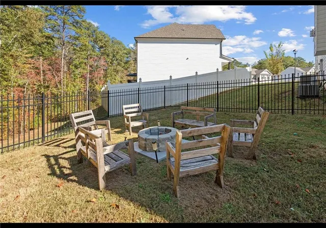 a view of a chairs and table in the backyard
