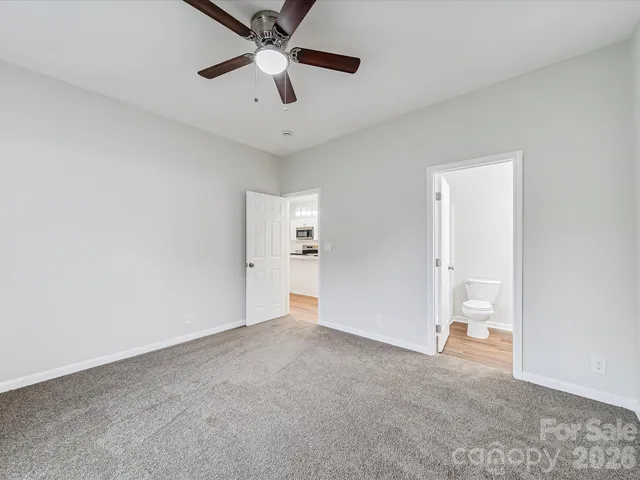 a view of an empty room with a ceiling fan