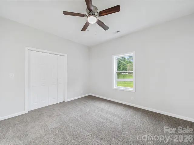 a bathroom with a bathtub shower sink vanity mirror and toilet