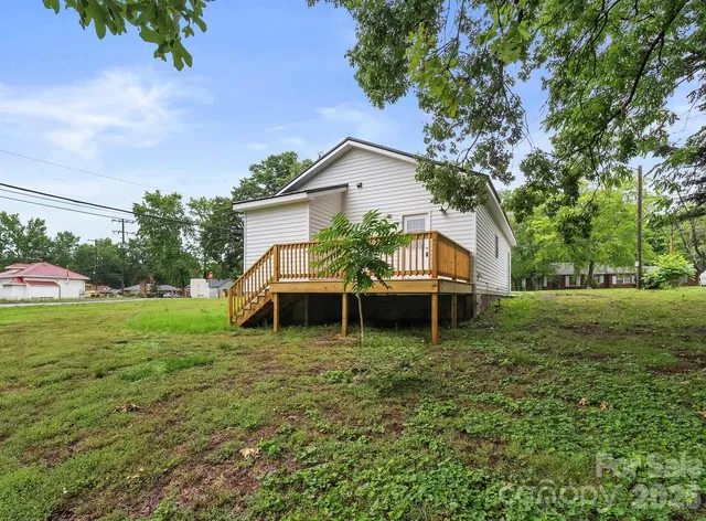 a backyard of a house with wooden floor and fence