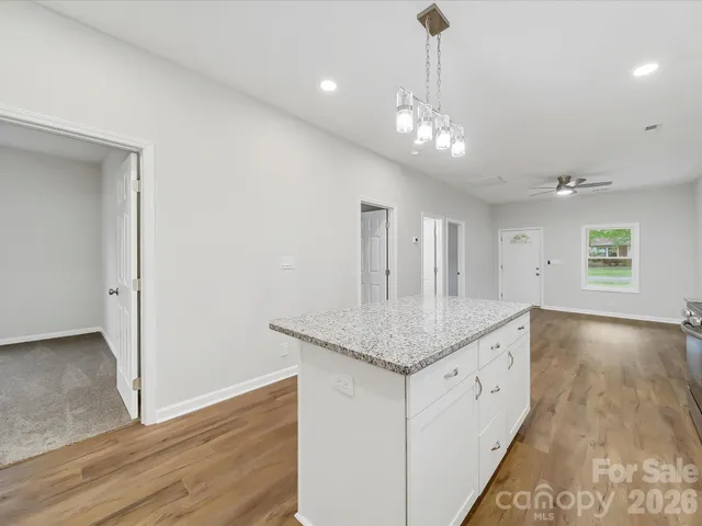 a view of an empty room with a ceiling fan