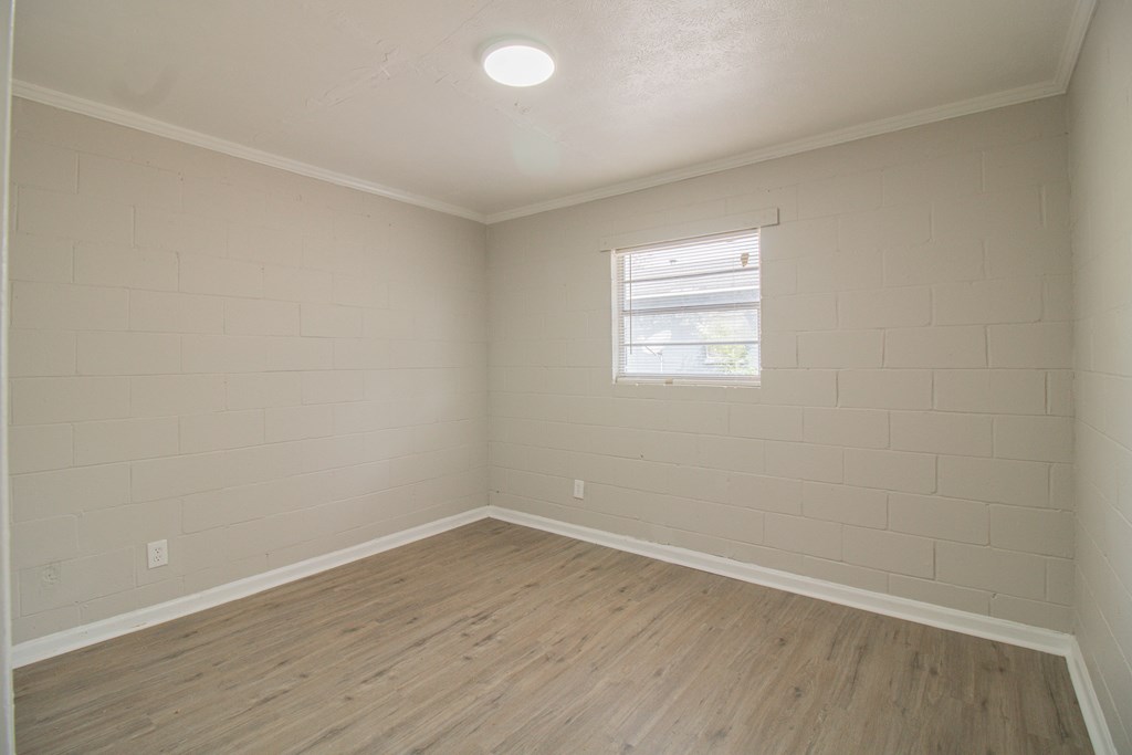 2408 16th Avenue, Unit B Columbus, GA 31901 - Photo 6 of 8 an empty room with wooden floor and windows