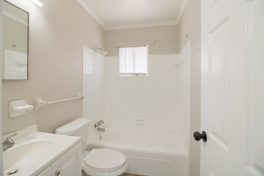 2408 16th Avenue, Unit B Columbus, GA 31901 - Photo 7 of 8 a white toilet sitting next to a bath tub