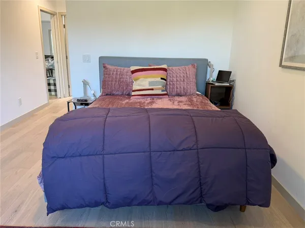 a bedroom with a bed and a large window