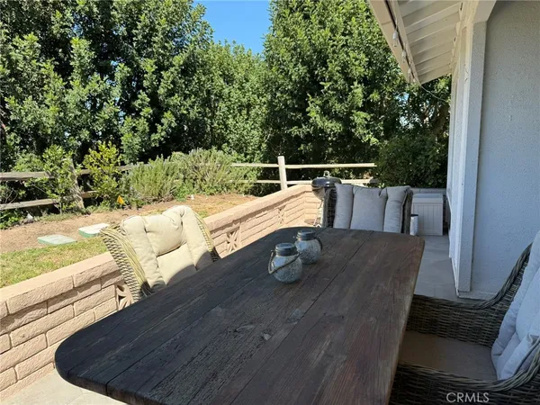 a backyard of a house with barbeque oven table and chairs