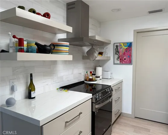 a kitchen with a sink a refrigerator and cabinets