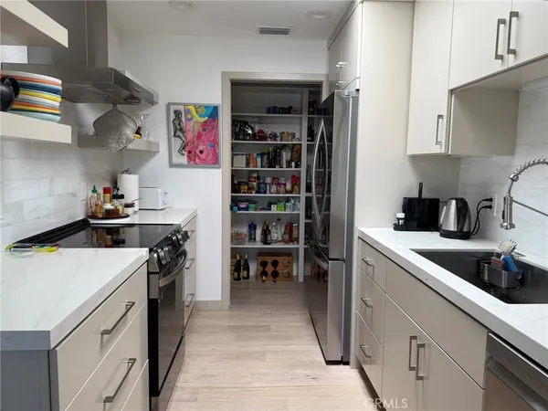 a kitchen with stainless steel appliances a refrigerator and a sink