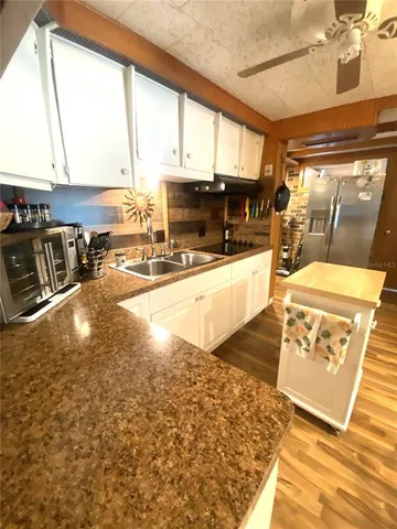 a living room with furniture floor to ceiling window and a fireplace