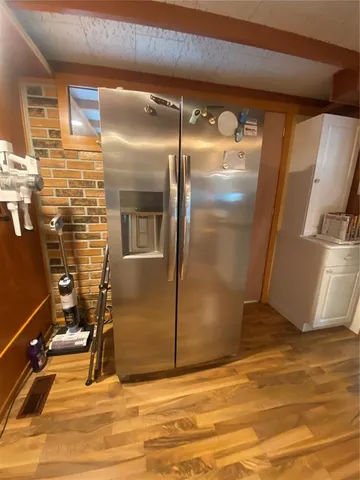 a kitchen with stainless steel appliances granite countertop a sink a stove and a wooden cabinets