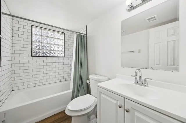 a bathroom with a sink a toilet and a bathtub