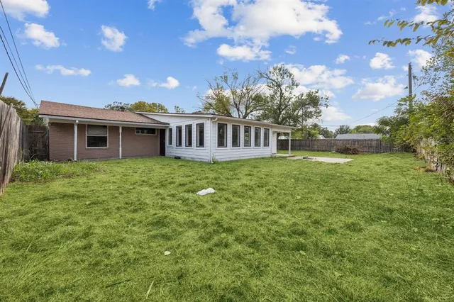 a view of a house with a yard and deck