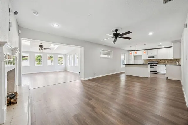 a view of a kitchen with a sink and a stove top oven