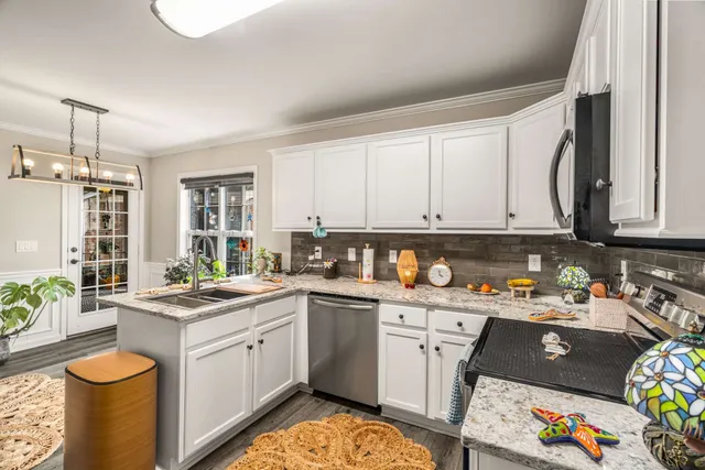 a kitchen with a sink a stove and cabinets