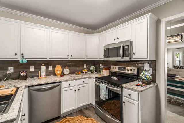 a kitchen with a sink stove top oven and cabinets
