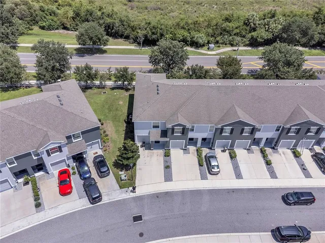 an aerial view of residential houses with outdoor space