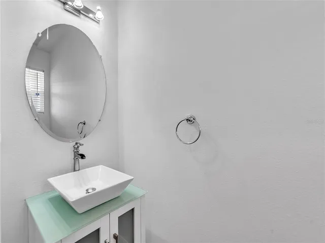 a bathroom with a sink a mirror and a window