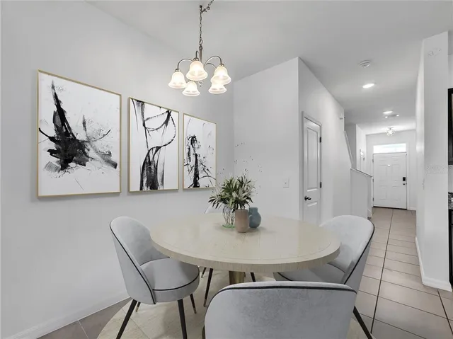 a view of a dining room with furniture and chandelier