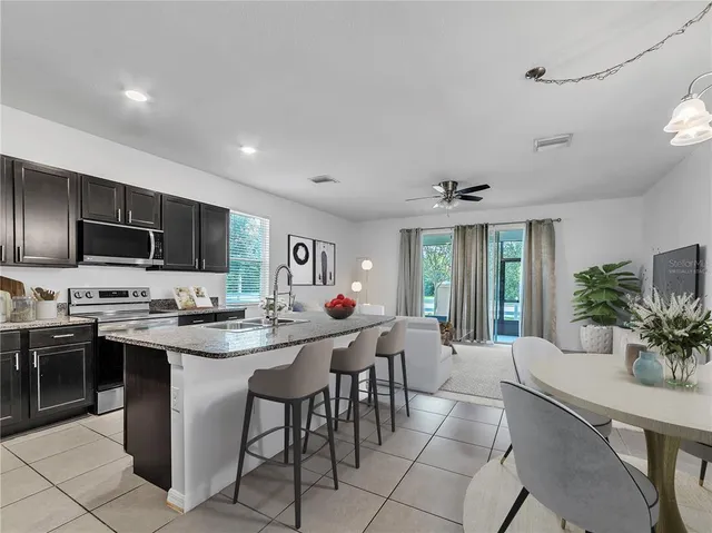 a view of a dining table chairs and potted plant