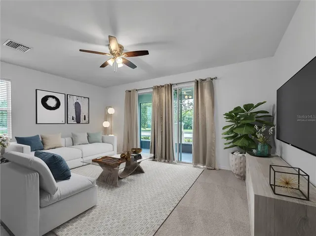 a living room with furniture and a potted plant