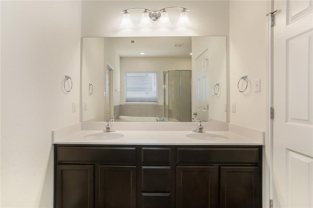 2233 Ringstaff Road Leander, TX 78641 - Photo 8 of 18 a bathroom with a sink vanity and a mirror