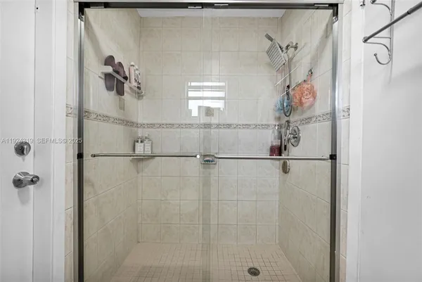 a bathroom with a window and a shower